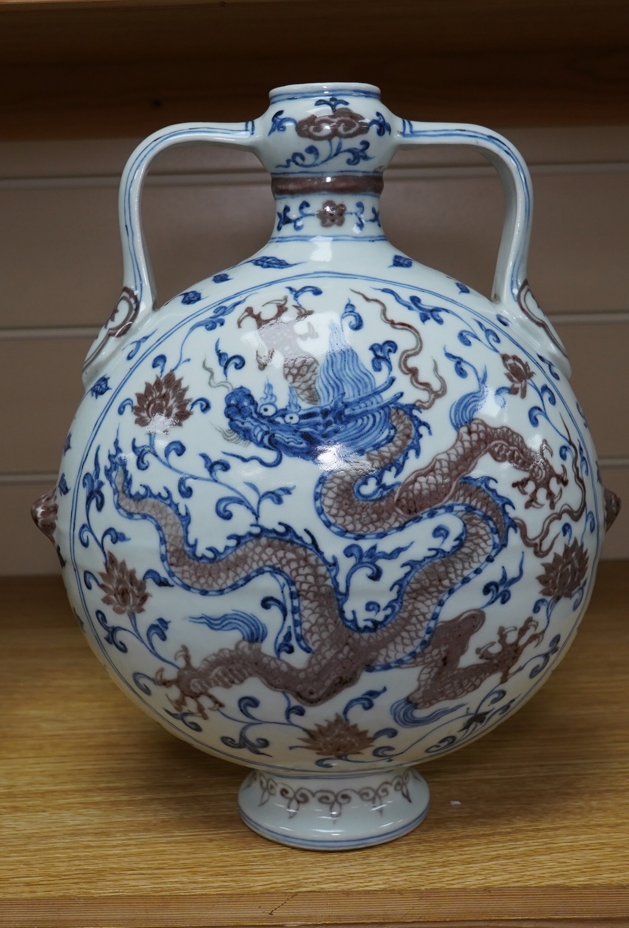 A Chinese blue and white with iron red two handled moon flask, 29cm high. Condition - good